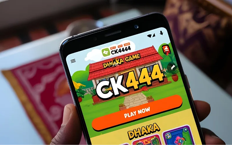 Smartphone showing CK444 gaming app with play button in Dhaka home